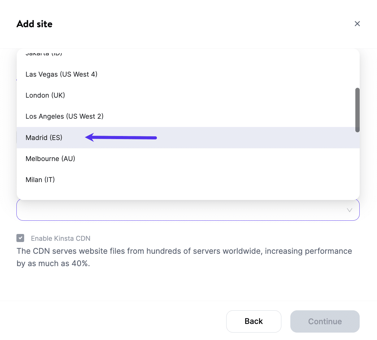 A screenshot of MyKinsta showing the "Add Site" location drop-down set to "Madrid (ES)".