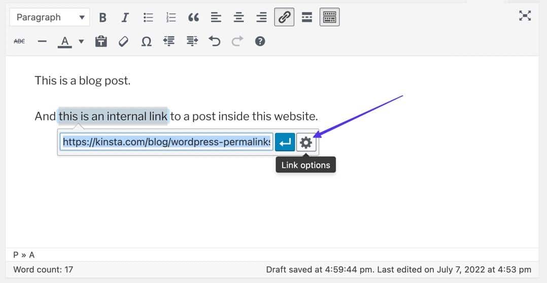 Schermata di un articolo nell’editor classico di WordPress: è aperto il campo per l’URL con il pulsante azzurro Applica per confermare l’inserimento. Una freccia indica la rotellina a fianco del pulsante Apply, e l’etichetta "Link options"