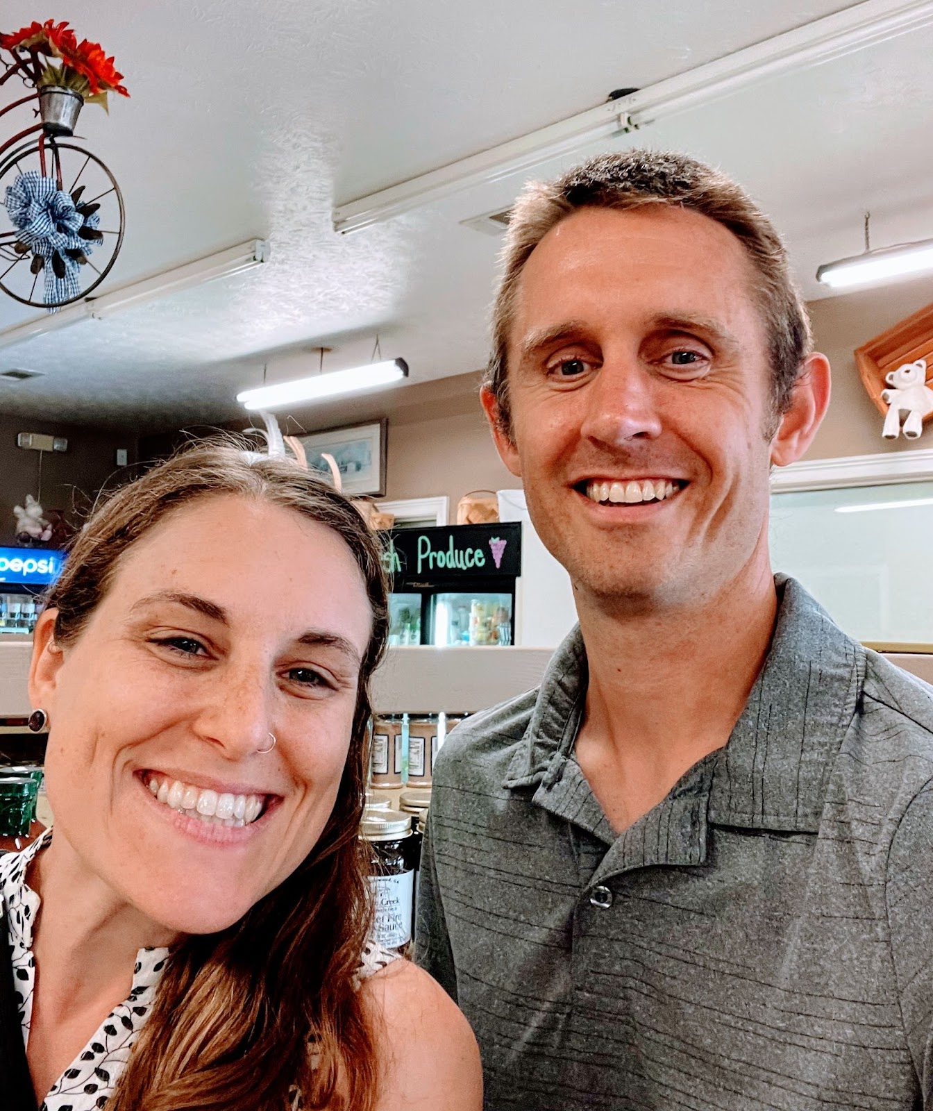 A woman standing next to a taller man, both smiling at the camera.