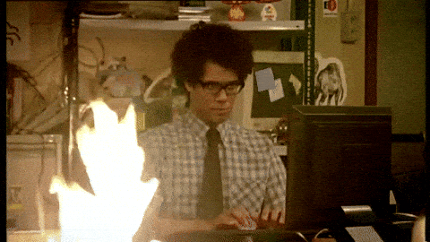 A character from The IT Crowd typing rapidly at a computer. GIF via GIPHY